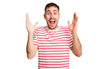 Young caucasian man cut out isolated receiving a pleasant surprise, excited and raising hands.