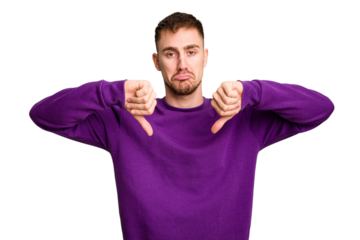 Young caucasian man cut out isolated showing a dislike gesture, thumbs down. Disagreement concept.