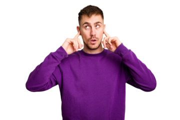 Young caucasian man cut out isolated covering ears with fingers, stressed and desperate by a loudly ambient.