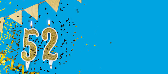 Golden candle number fifty two. Birthday or anniversary card with the inscription 52 on blue background. Anniversary celebration. Banner.