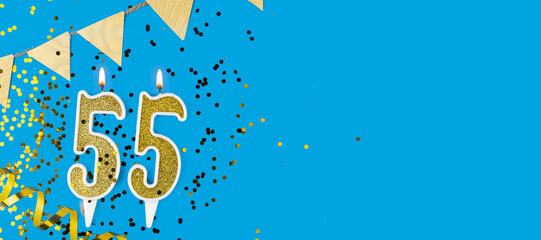 Golden candle number fifty five. Birthday or anniversary card with the inscription 55 on blue...