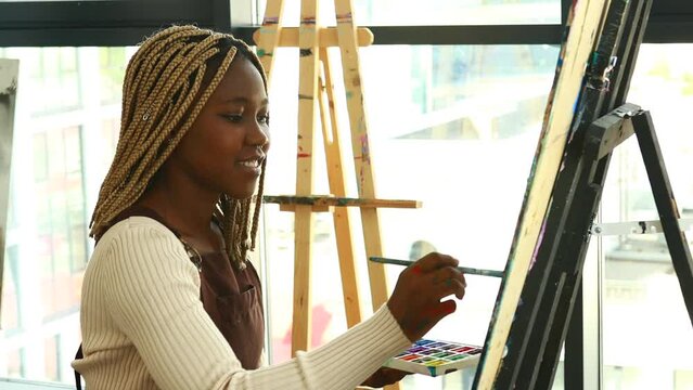 Young african student with septum nose piercing at the art studio