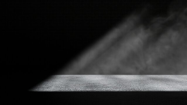Light falling on concrete floor in a dark dusty room