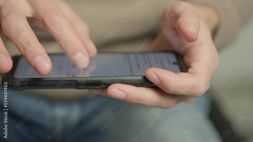 Poster A man's finger touches a monitor to scroll a page on a mobile phone. Viewing photos and documents in the smartphone library. A man in his hands uses a smartphone, turns pages.