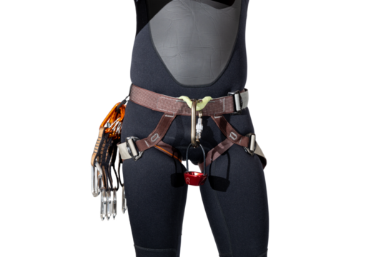 Person wearing rock climbing harness with carabiners, quickdraws, and atc belay device wearing a black wetsuit for outdoor adventures isolated on a white background. 