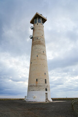 Fototapeta premium Morro Jable lighthouse, built out of concrete in 1991 on marshland on the Jandia Peninsula of Fuerteventura in the Canary Islands, Spain