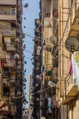 Narrow alley with satellite dishes in Alexandria, Egypt