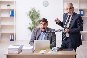 Two male employees in bullying concept