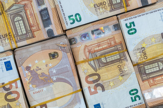 Stacks of 50 euro notes tied with rubber bands. Close-up