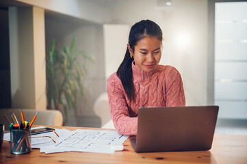 Portrait of a Vietnamese Asian woman using a laptop at home