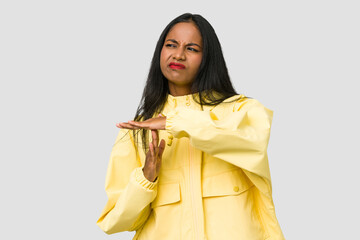 Young Indian woman cut out isolated on white background showing a timeout gesture.