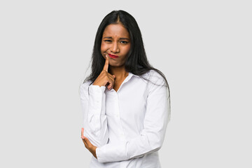 Young Indian woman cut out isolated on white background unhappy looking in camera with sarcastic...