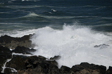 Ocean waves crashing against a rocky shore