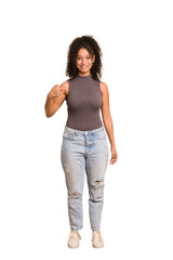 Young african american woman with curly hair cut out isolated person pointing by hand to a shirt copy space, proud and confident