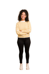 Fototapeta premium Young african american woman with curly hair cut out isolated who feels confident, crossing arms with determination.