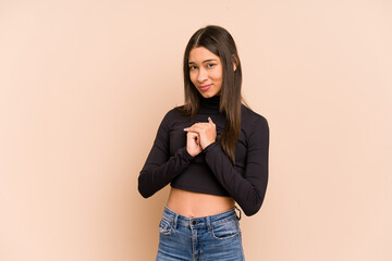 Young colombian woman isolated on beige background scared and afraid.
