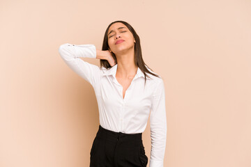 Young colombian woman isolated on beige background massaging elbow, suffering after a bad movement.