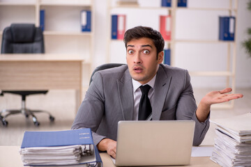 Young male employee working in the office