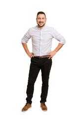 Full body adult latin man cut out isolated confident keeping hands on hips.