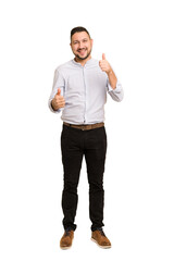 Full body adult latin man cut out isolated raising both thumbs up, smiling and confident.