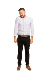 Fototapeta premium Full body adult latin man cut out isolated laughs and closes eyes, feels relaxed and happy.