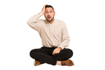 Adult latin man sitting on the floor cut out isolated being shocked, she has remembered important meeting.