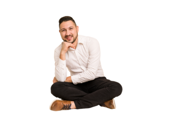 Adult latin man sitting on the floor cut out isolated smiling happy and confident, touching chin with hand.