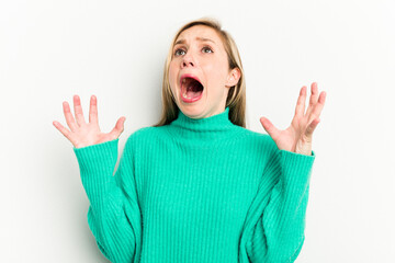 Young caucasian woman isolated on white background screaming to the sky, looking up, frustrated.