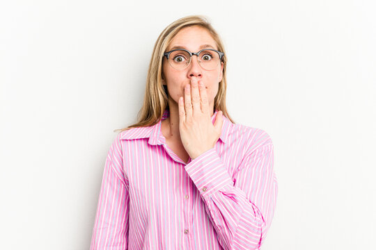 Young caucasian woman isolated on white background shocked, covering mouth with hands, anxious to discover something new.