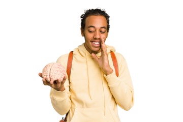 Young African American man holding a brain isolated is saying a secret hot braking news and looking aside