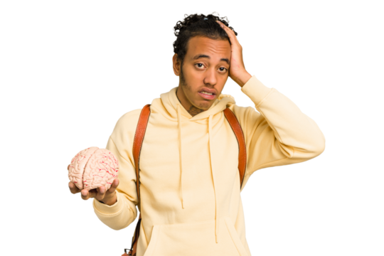 Young African American man holding a brain isolated being shocked, she has remembered important meeting.