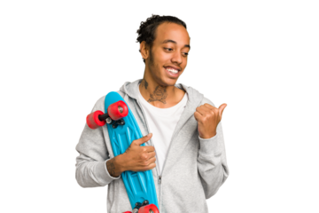 Young skater African American man isolated points with thumb finger away, laughing and carefree.