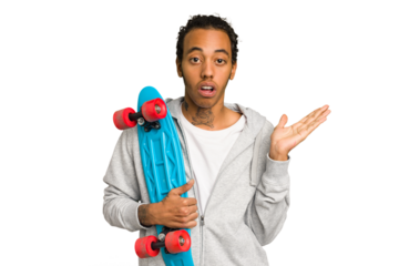 Young skater African American man isolated surprised and shocked.