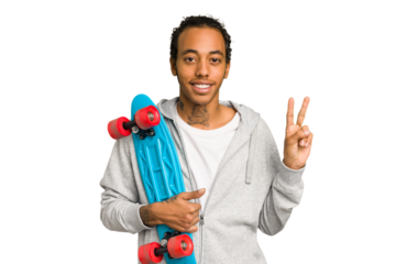 Young skater African American man isolated joyful and carefree showing a peace symbol with fingers.