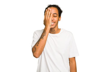 Young African American man isolated having fun covering half of face with palm.