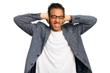 Young African American man isolated covering ears with hands trying not to hear too loud sound.