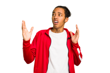 Young African American man isolated screaming to the sky, looking up, frustrated.