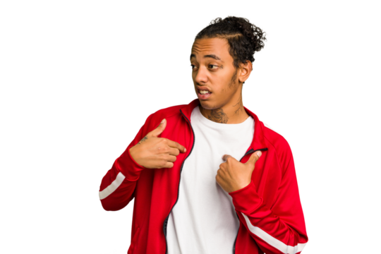 Young African American man isolated surprised pointing with finger, smiling broadly.