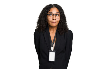 Young african american business woman with ID card isolated confused, feels doubtful and unsure.