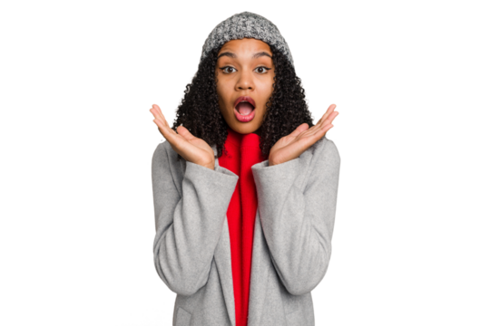 Young african american woman wearing winter jacket isolated surprised and shocked.