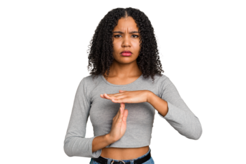 Young african american woman with curly hair cut out isolated showing a timeout gesture.