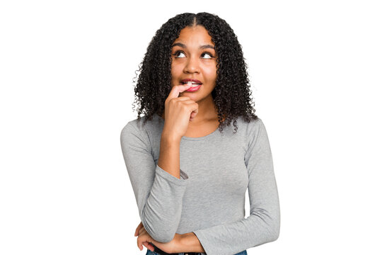 Young african american woman with curly hair cut out isolated looking sideways with doubtful and skeptical expression. - Powered by Adobe