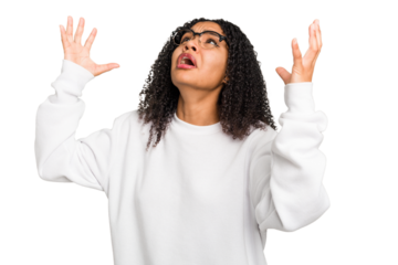 Young african american woman with curly hair cut out isolated screaming to the sky, looking up, frustrated.