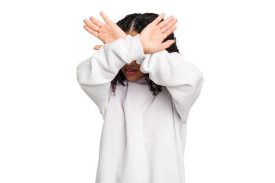 Young african american woman with curly hair cut out isolated keeping two arms crossed, denial concept.