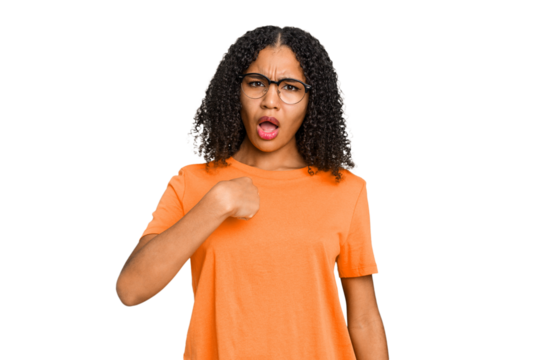 Young african american woman with curly hair cut out isolated surprised pointing with finger, smiling broadly.