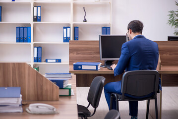 Young male employee working in the office