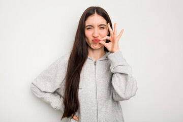 Young caucasian woman isolated on white background with fingers on lips keeping a secret.