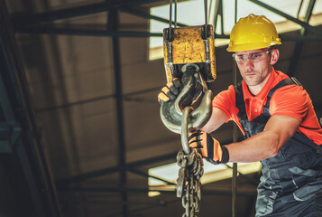 Construction Worker Operating an Overhead Crane at Building Site - Powered by Adobe