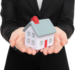 Real estate agent showing mini house / home closeup of female realtor hands showing miniature model house isolated in transparent PNG.