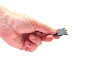 SD memory card in a hand on a white background. Copy space.